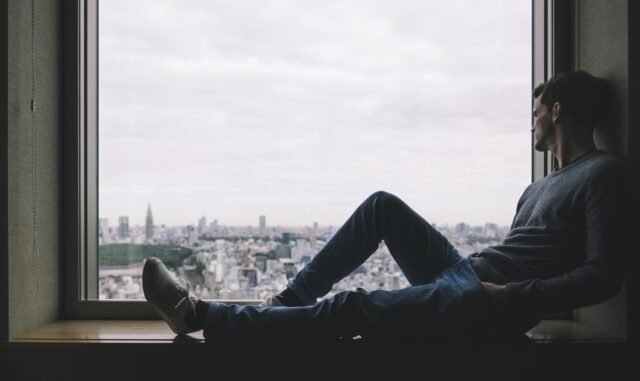 person working peacefully near window showing how to overcome procrastination naturally